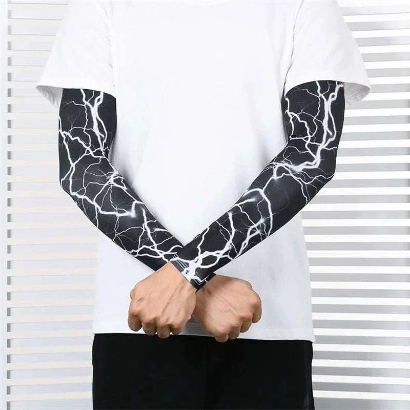 Man wearing black and white lightning patterned outdoor arm sleeves on both arms with white t-shirt and black pants