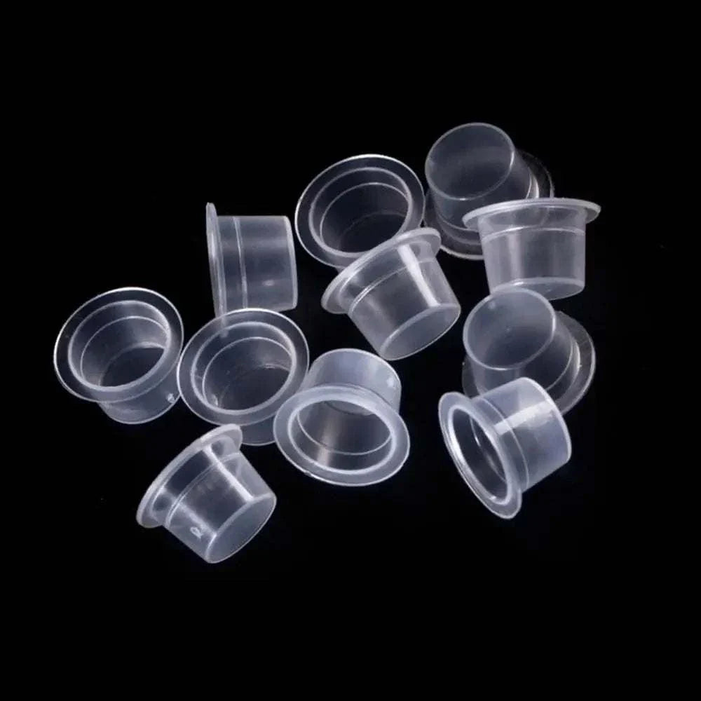 Clear disposable plastic ink cups in assorted sizes for tattoo and permanent makeup pigment holders
