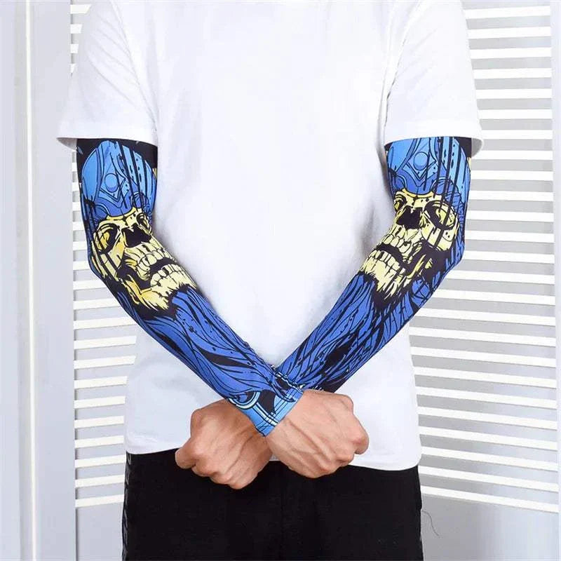 Pair of blue outdoor arm sleeves with skull design worn on both arms, providing UV protection and compression for sports and tattoo cover