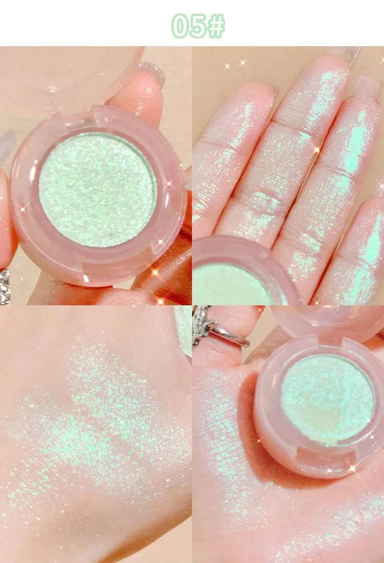 Close-up of diamond glitter monochrome eyeshadow with shimmering mint green sparkle swatched on fingers and hand, showcasing high-pigment, blendable, and waterproof formula.