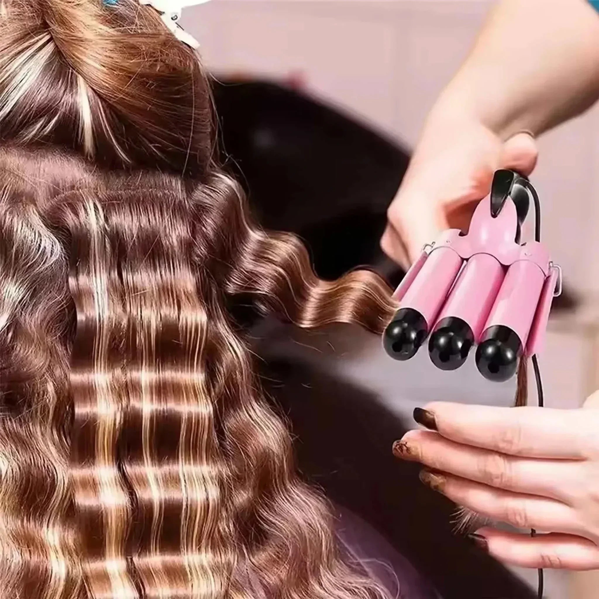 Multifunctional curling iron creating waves on hair with pink triple barrel design
