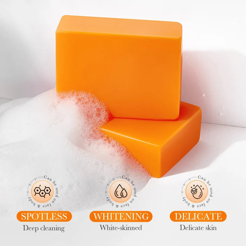 Bright orange SADOER Kojic Acid Facial Soap bars with rich foam for deep cleaning, whitening, and delicate skin care.