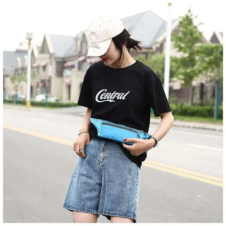 Woman wearing a blue nylon waist and chest bag with adjustable strap, styled casually for outdoor use