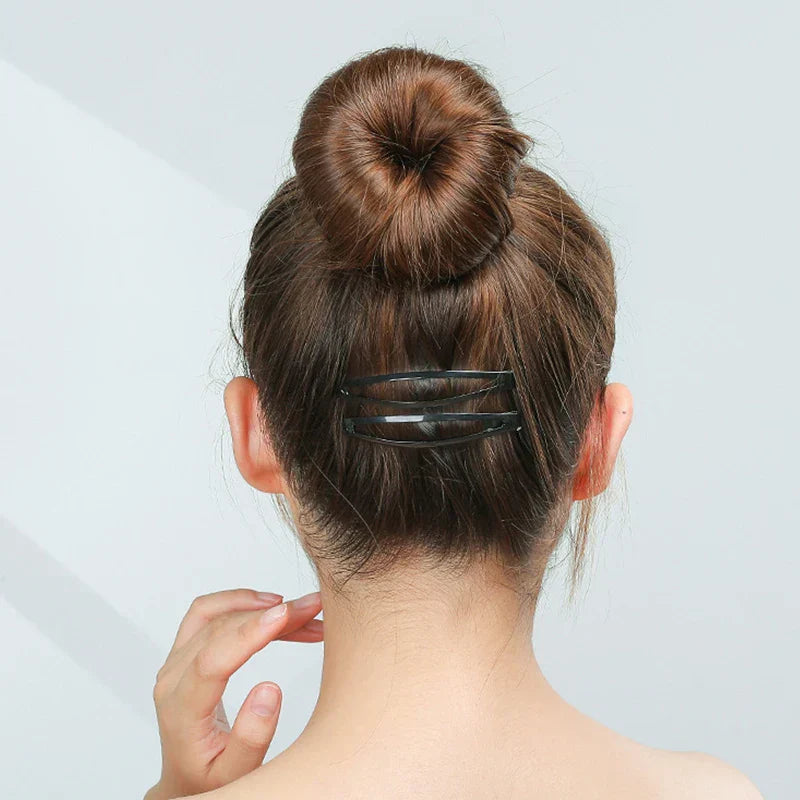 Back view of woman with bun hairstyle secured by frosted alloy snap hair clips in matte black finish