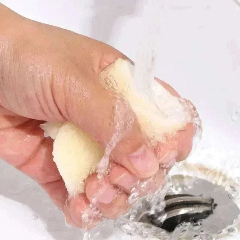 Hand squeezing natural lamb fleece insole under running water to demonstrate moisture-wicking and softness qualities