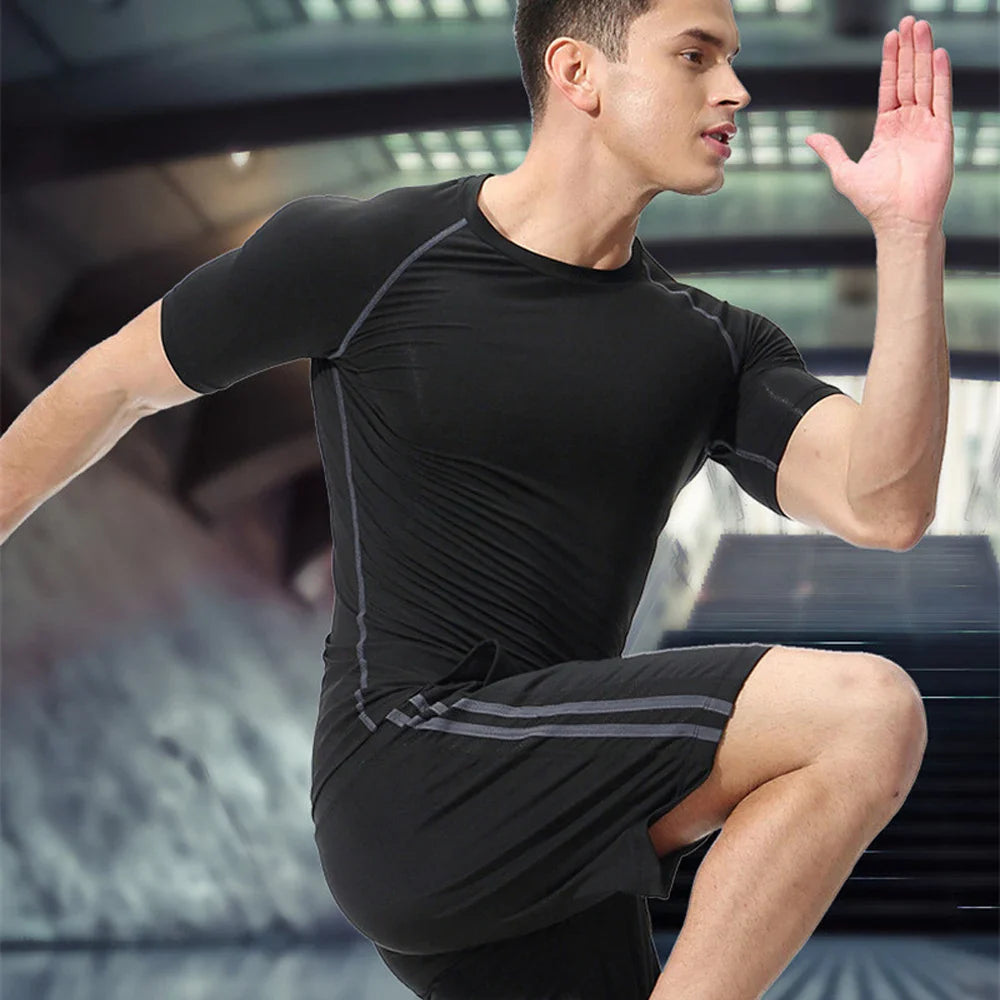 Man wearing black Anime Jujutsu Kaisen Sukuna compression t-shirt in athletic pose
