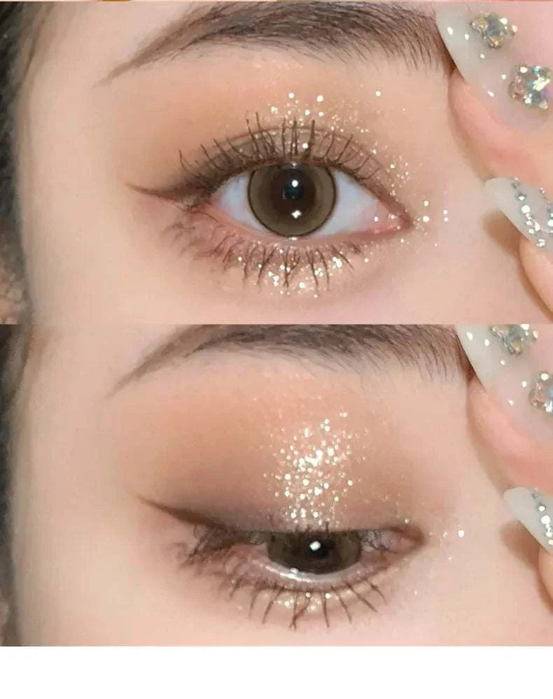 Close-up of eye makeup featuring shimmering diamond glitter eyeshadow with monochrome brown tones and subtle cat eyeliner, highlighting glossy nails with rhinestone accents.