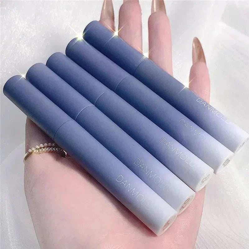 Matte Lipstick Set with 5 vibrant, long-lasting, waterproof shades in sleek blue tubes, held in hand.