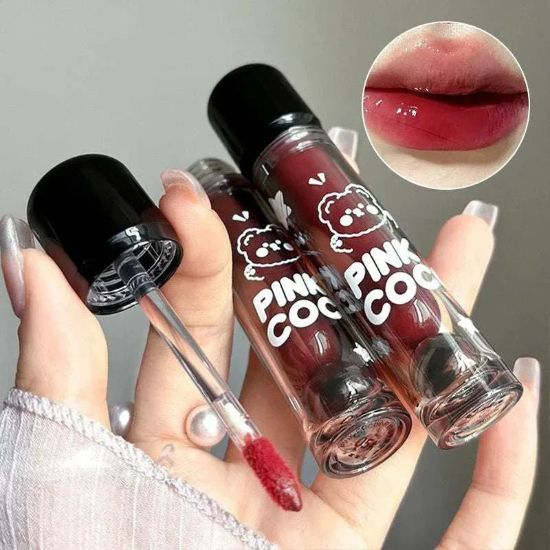 PINKCOCO Bear Doodle Mirror Lip Glaze in transparent tube with cute bear design, showing glossy red lip color application