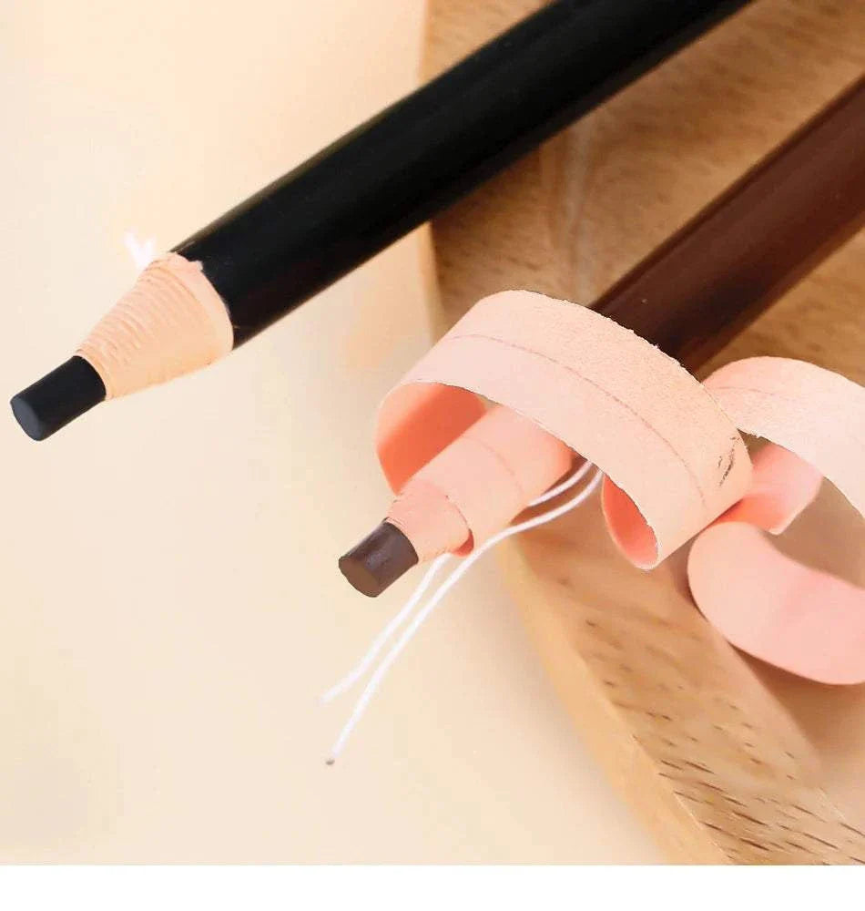 Close-up of black and brown eyebrow pencils with sharpened tips and wood shavings on a light surface, showcasing the eyebrow pencil and trimmer set for precise brow grooming.