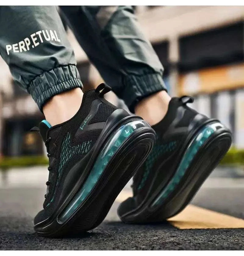 Men's casual air cushion running shoes with breathable mesh upper and visible air cushion sole in black and teal colors on asphalt background