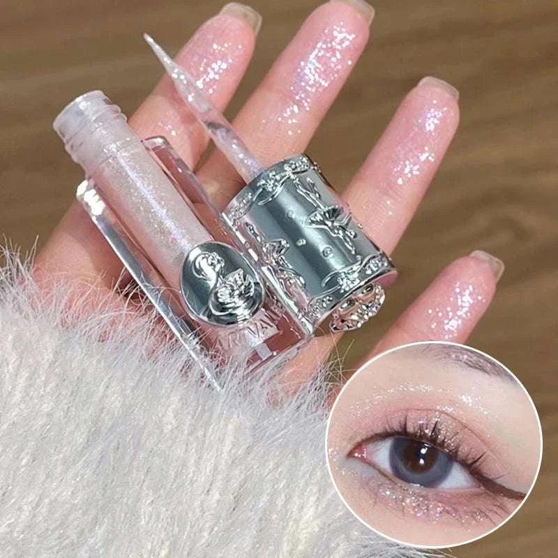 Balletism Liquid Eyeshadow with fine shimmer highlight and elegant silver packaging on hand and applied on eyelid, showing smooth, radiant glow