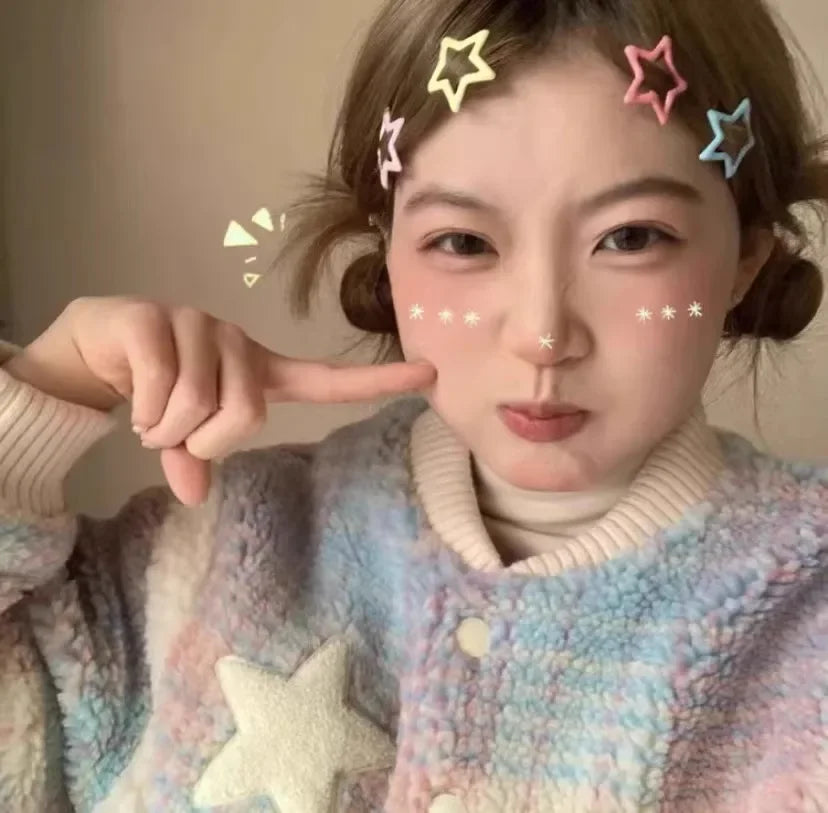 Girl wearing colorful kawaii star barrettes in pastel hair clips with a soft sweater