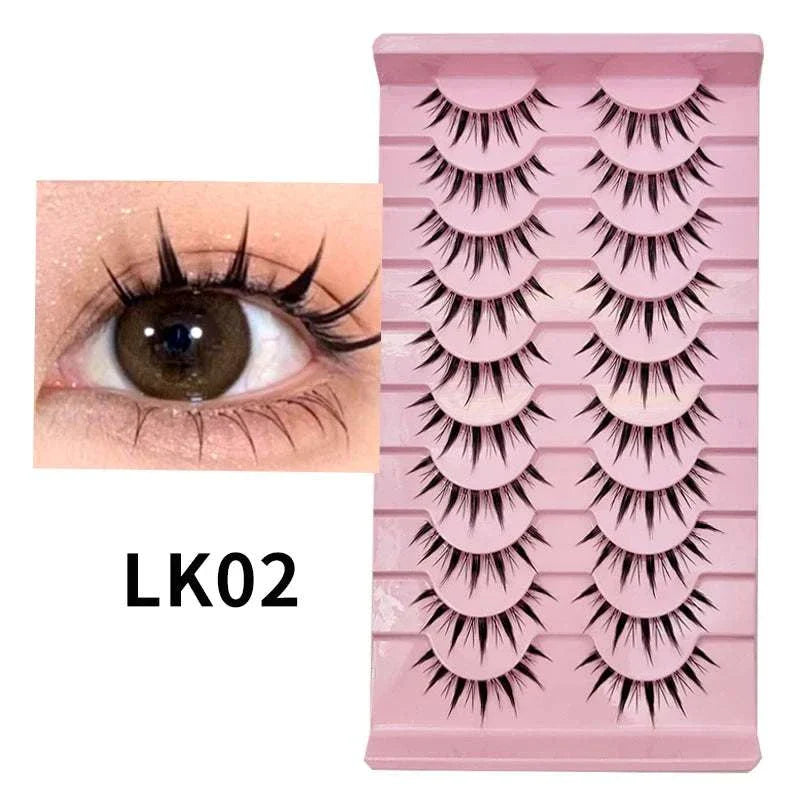 10 pairs of Natural Manga Full Strip Lashes with voluminous, anime-inspired design displayed on pink tray with close-up eye showing dramatic fluttery lash effect