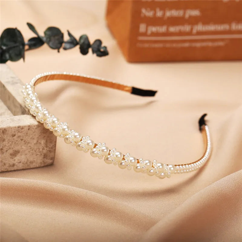 Modyle Full Pearl Hairband with elegant floral pearl design and elastic fit on beige satin background