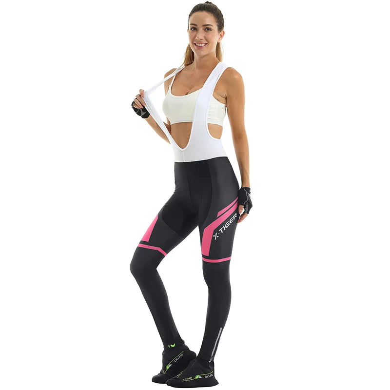 Woman wearing X-Tiger Women's Anti-Shock Cycling Pants with 5D gel padding and ergonomic fit, standing and smiling against white background
