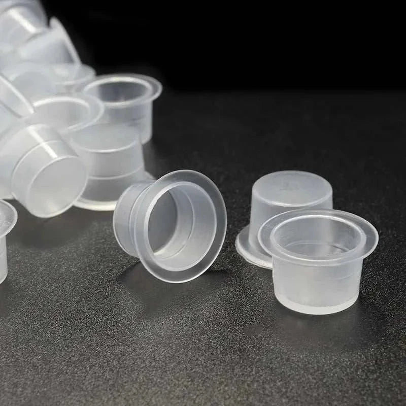 100-pack transparent disposable plastic ink cups in assorted sizes for tattoo and permanent makeup pigment holding
