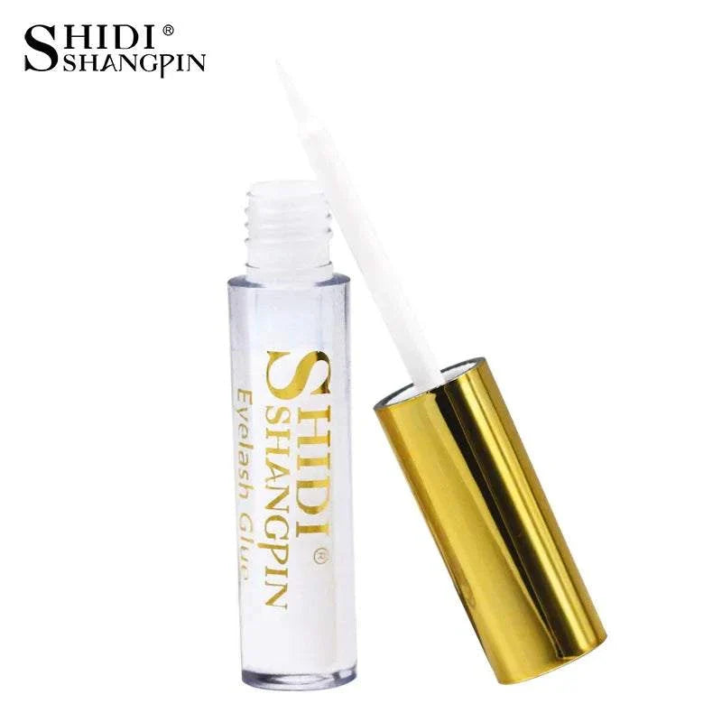 clear eyelash glue with gold cap in transparent container