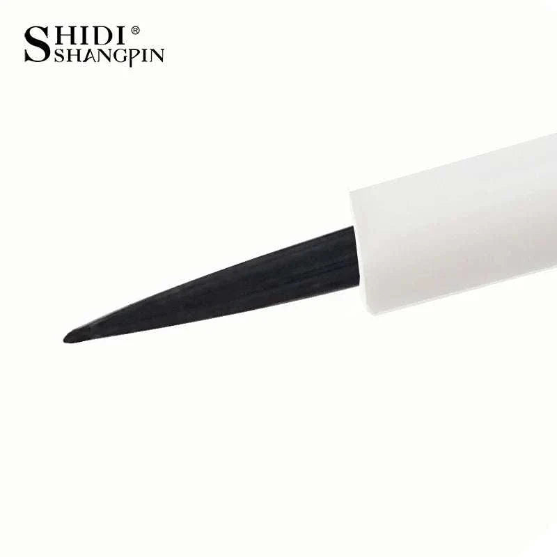 Close-up of black eyeliner brush tip with white handle on white background