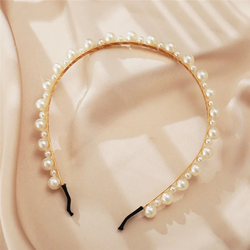 Modyle Full Pearl Hairband with elegant floral pearl design and elastic fit on beige fabric background