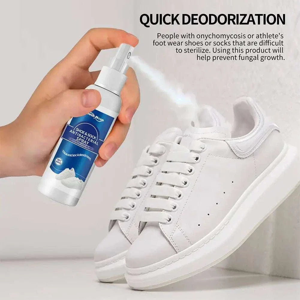 Hand spraying 60ml antibacterial shoe and foot odor spray on white sneakers to quickly deodorize and prevent fungal growth.