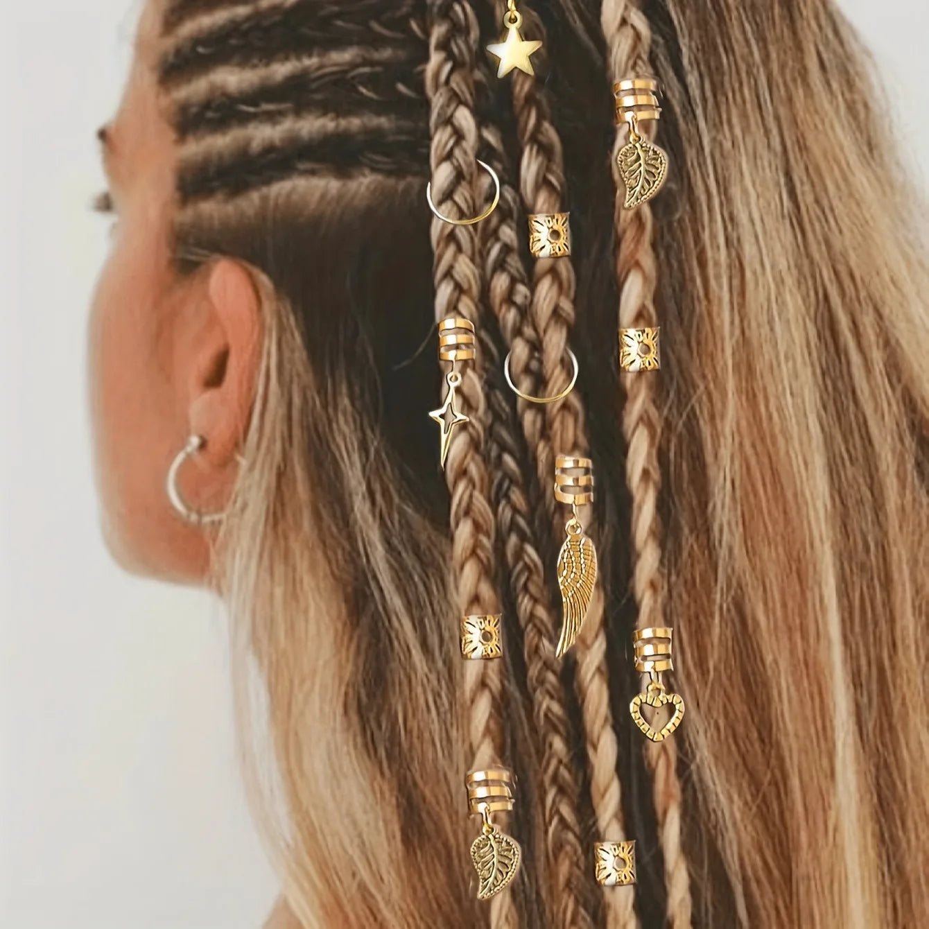 Close-up of braided hair adorned with gold alloy braid hair ring set featuring various charms and cuffs
