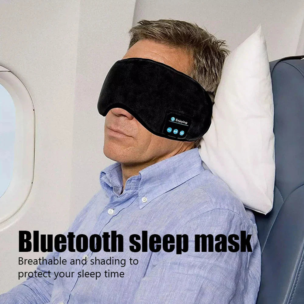 Man wearing Fone Bluetooth Earphones sports sleeping headband mask on airplane seat with pillow for comfortable sleep and noise isolation