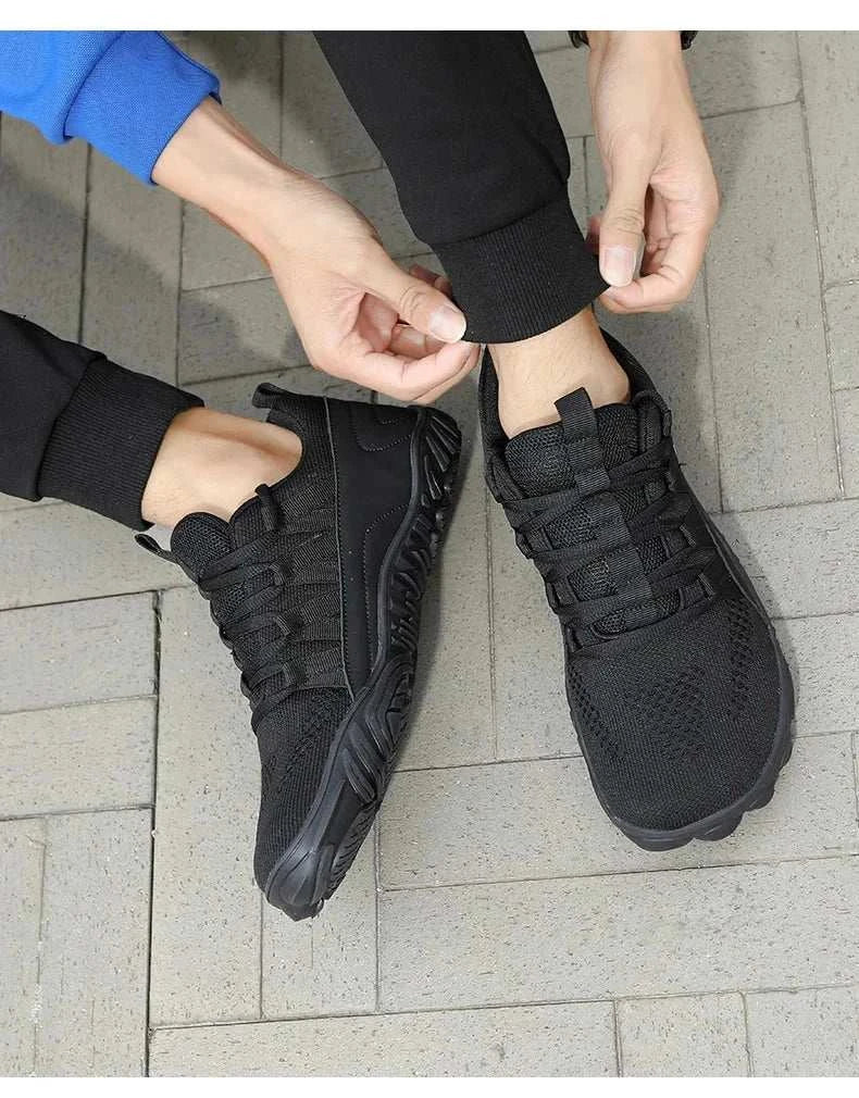 Black breathable new hiking shoes with flexible soles and slip-on design on person outdoors