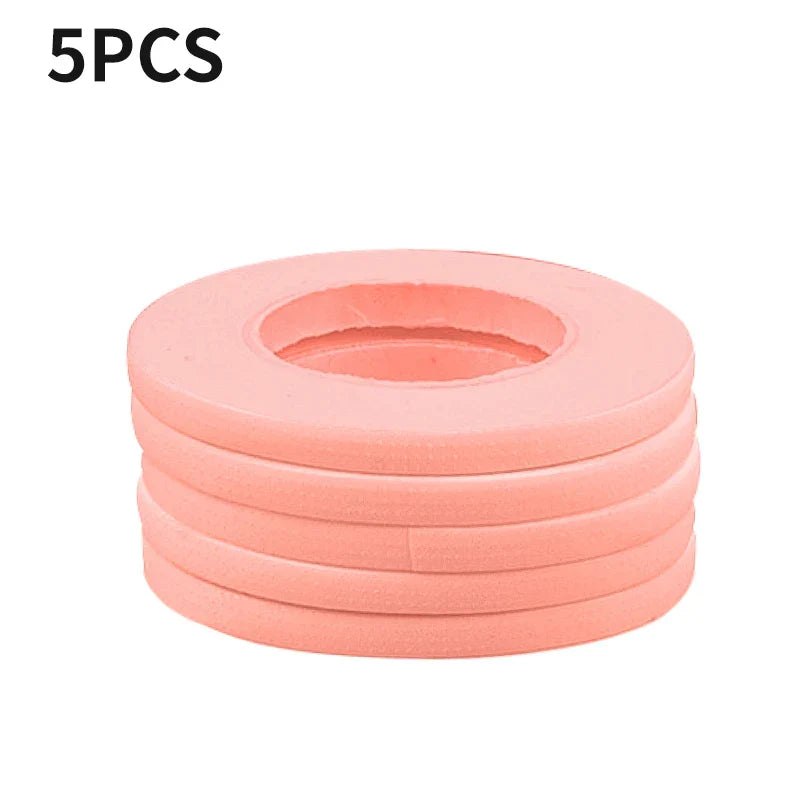 Stack of five pink micropore eyelash extension tapes for gentle, breathable lash application