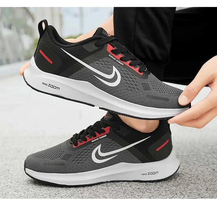 Men's lightweight running shoes with breathable mesh, non-slip rubber outsole, and cushioned memory foam insole in black with red and white accents