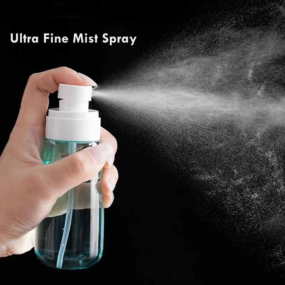 Hand holding mini travel spray bottle dispensing fine mist spray