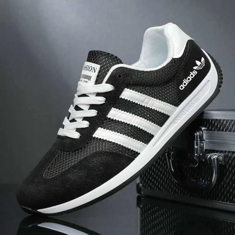 Black and white breathable men's casual sport shoe with mesh upper and cushioned insole for lightweight comfort and flexible outsole for grip.