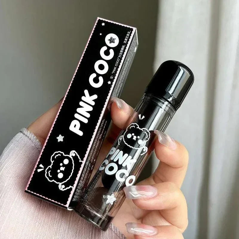 PINKCOCO Bear Doodle Mirror Lip Glaze in transparent tube with black cap and cute bear doodle packaging held by hand with matching box in black and white design