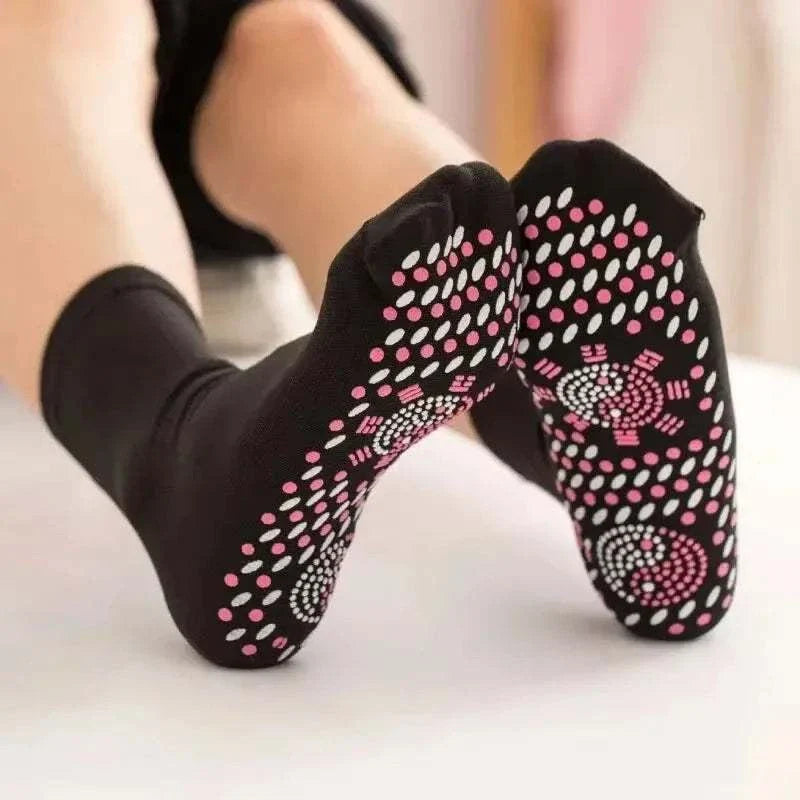 Non-slip black socks with pink and white grip dots for personal health care and wellness.