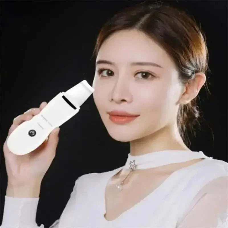 Woman holding a white handheld blackhead remover device for deep pore cleansing and acne care.