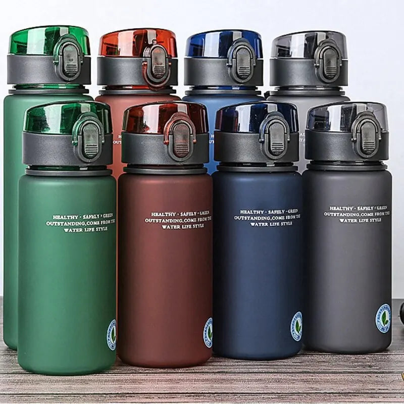 BPA-free leak-proof sports water bottles in green, red, blue, and gray with secure flip-top lids for hiking and fitness.