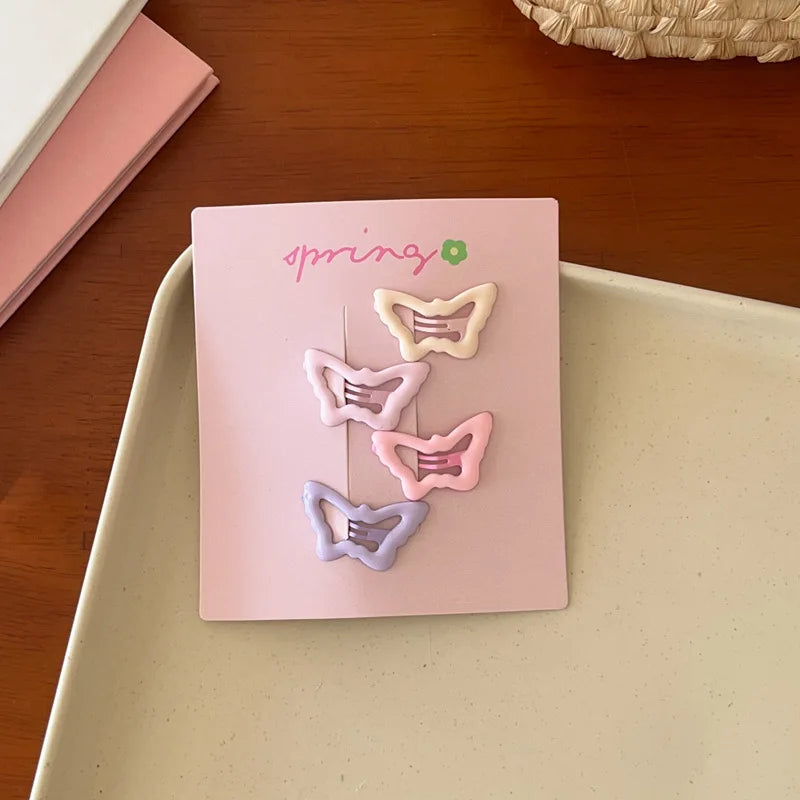 Set of 4 cute colorful geometric mini butterfly hair clips on pink card