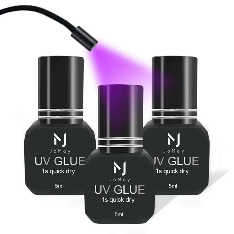 JOMAY UV Glue Adhesive bottles curing under purple UV light for fast-drying lash extensions.