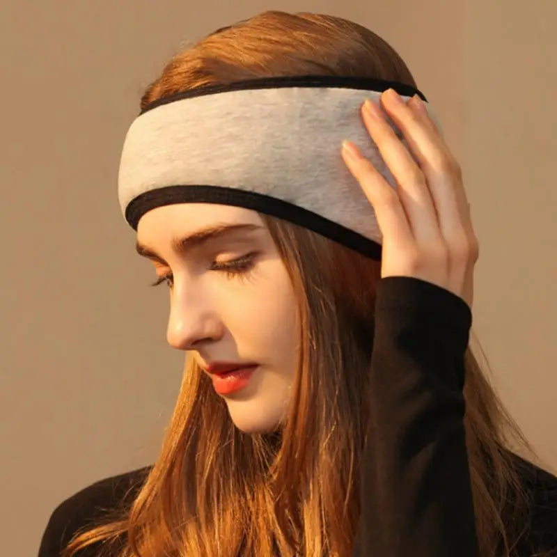 Young woman wearing adjustable grey eye mask with noise-reducing sleep earplugs for restful sleep
