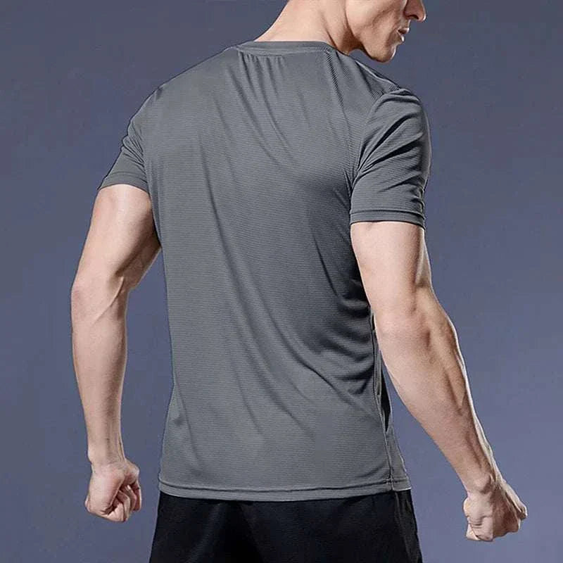 Back view of a man wearing a gray men's quick-dry compression sport t-shirt for fitness and training