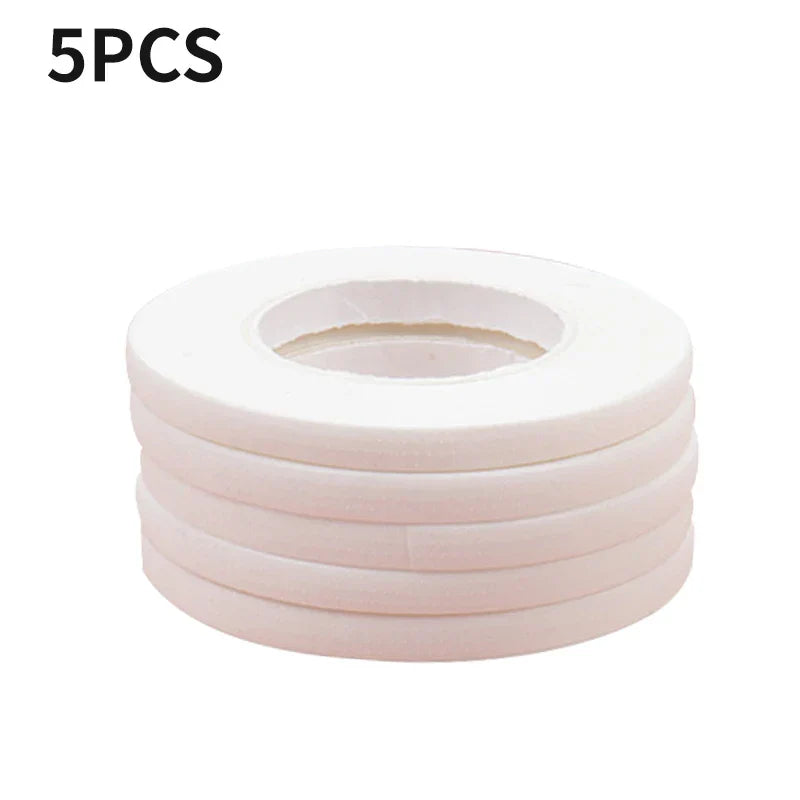 Stack of five white micropore eyelash extension tapes for lower lash application