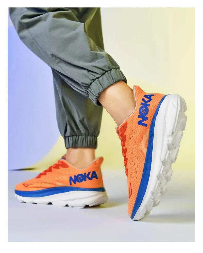 Orange carbon plate air cushion running shoes with blue branding and white sole on person wearing green pants