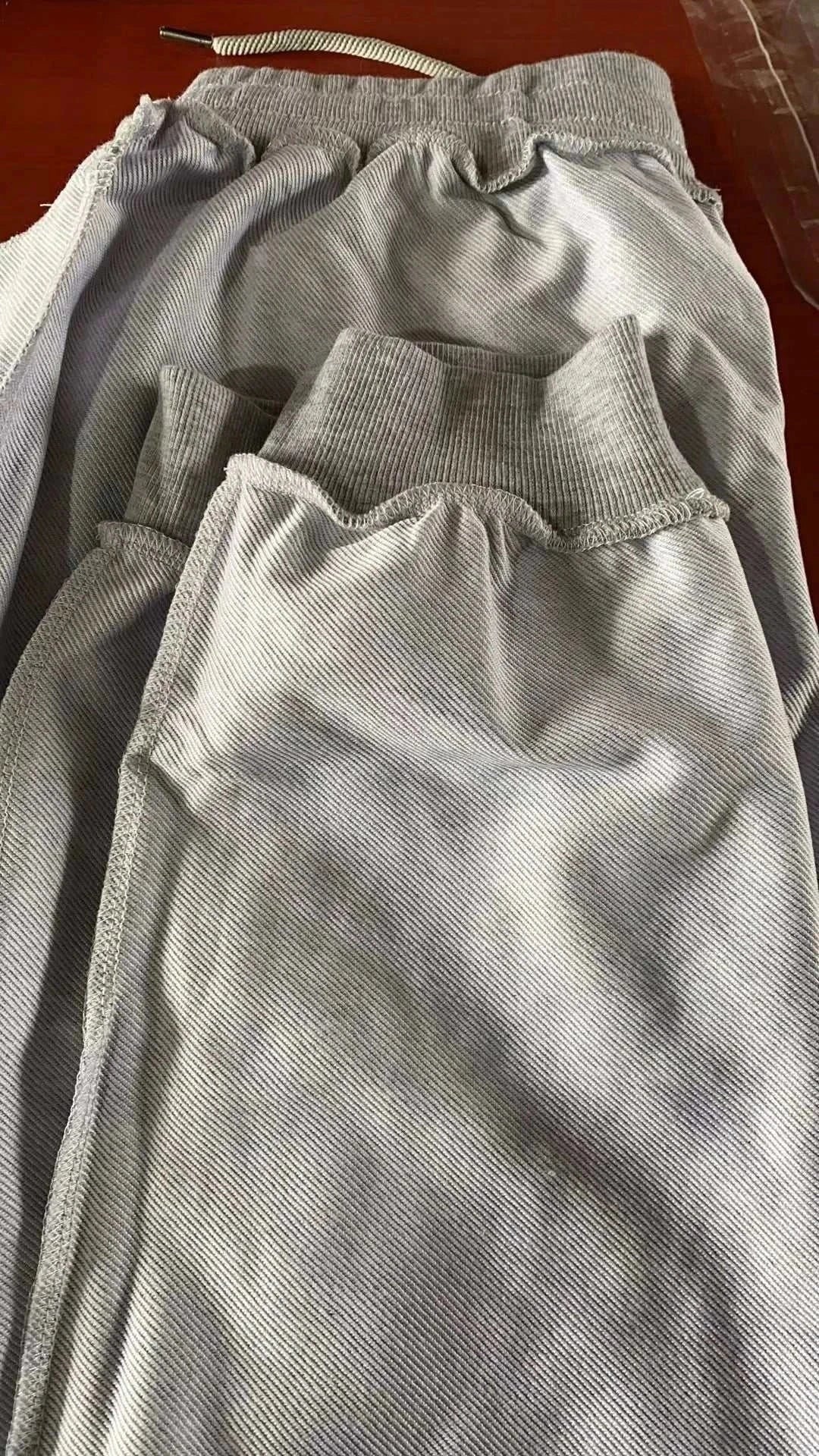 Men's Training Jogger Sweatpants in light grey with elastic waistband and drawstring for adjustable fit, designed for comfort and performance.