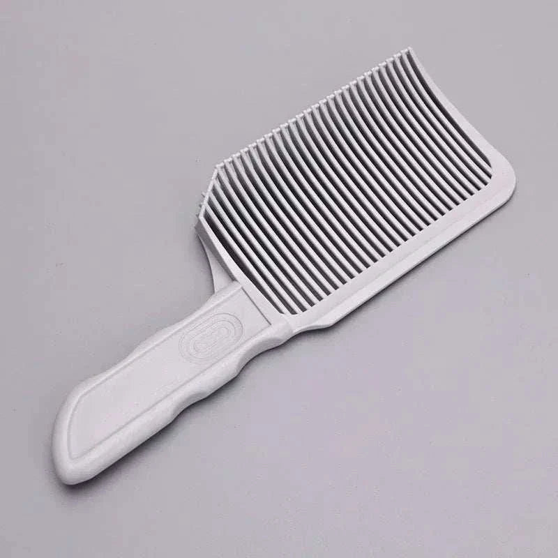 White barber fade comb hair cutting tool with ergonomic handle and wide, evenly spaced teeth for precision fades and flat tops.