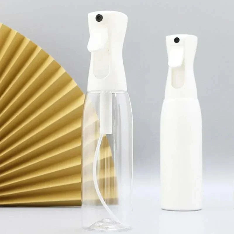 Two high pressure mist spray bottles, one transparent and one solid white, with ergonomic white spray nozzles against a neutral background.