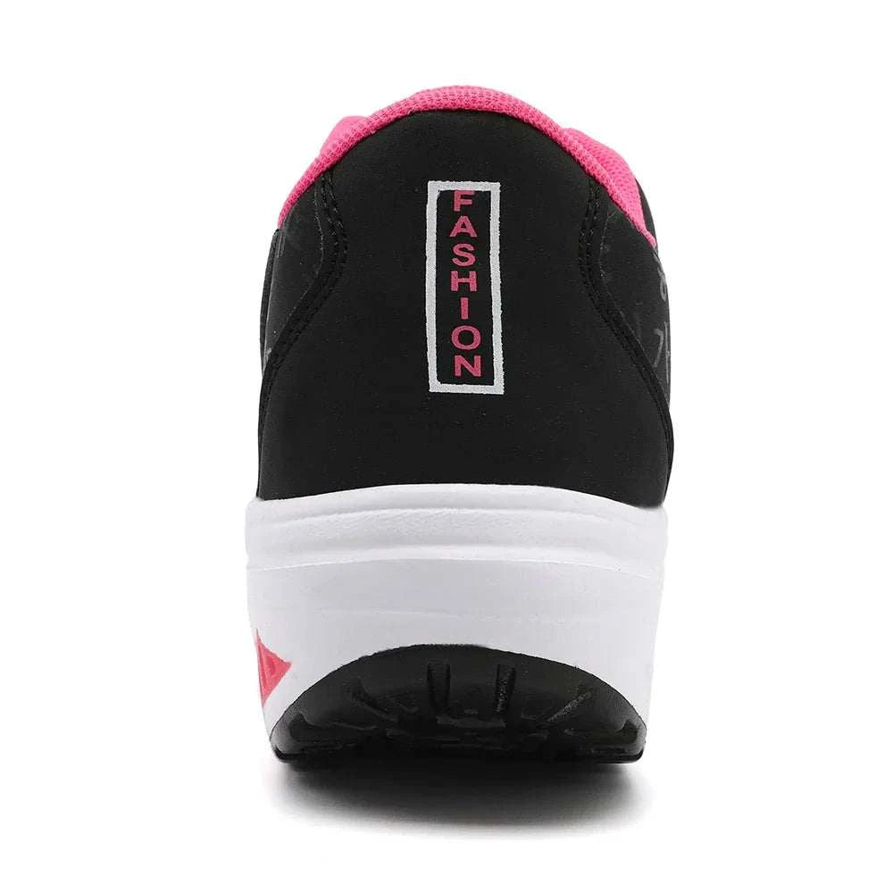 Back view of breathable wedge heel sneaker in black with pink lining and white sole, designed for casual sports and comfort