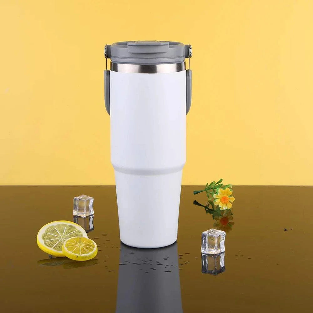 30oz white vacuum insulated cup with handle and leak-resistant lid on reflective surface with lemon slices and ice cubes