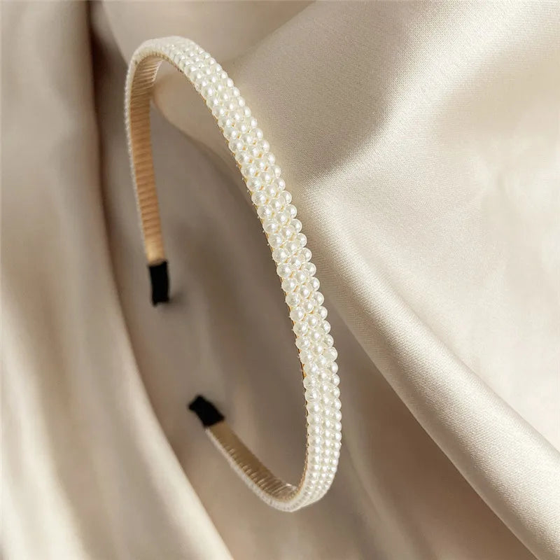 Modyle Full Pearl Hairband with elegant floral pearls and elastic fit on satin background