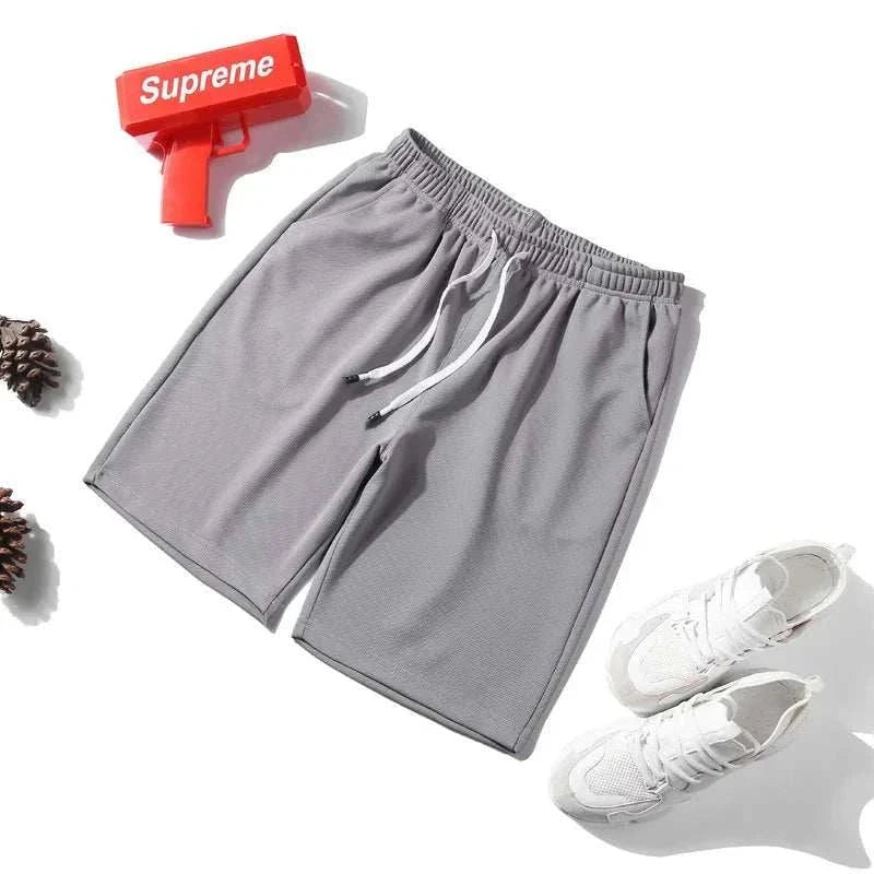 Gray men's 2025 NEW Fitness Sports Shorts with elastic waistband, lightweight and quick-drying fabric, styled for athletic performance.