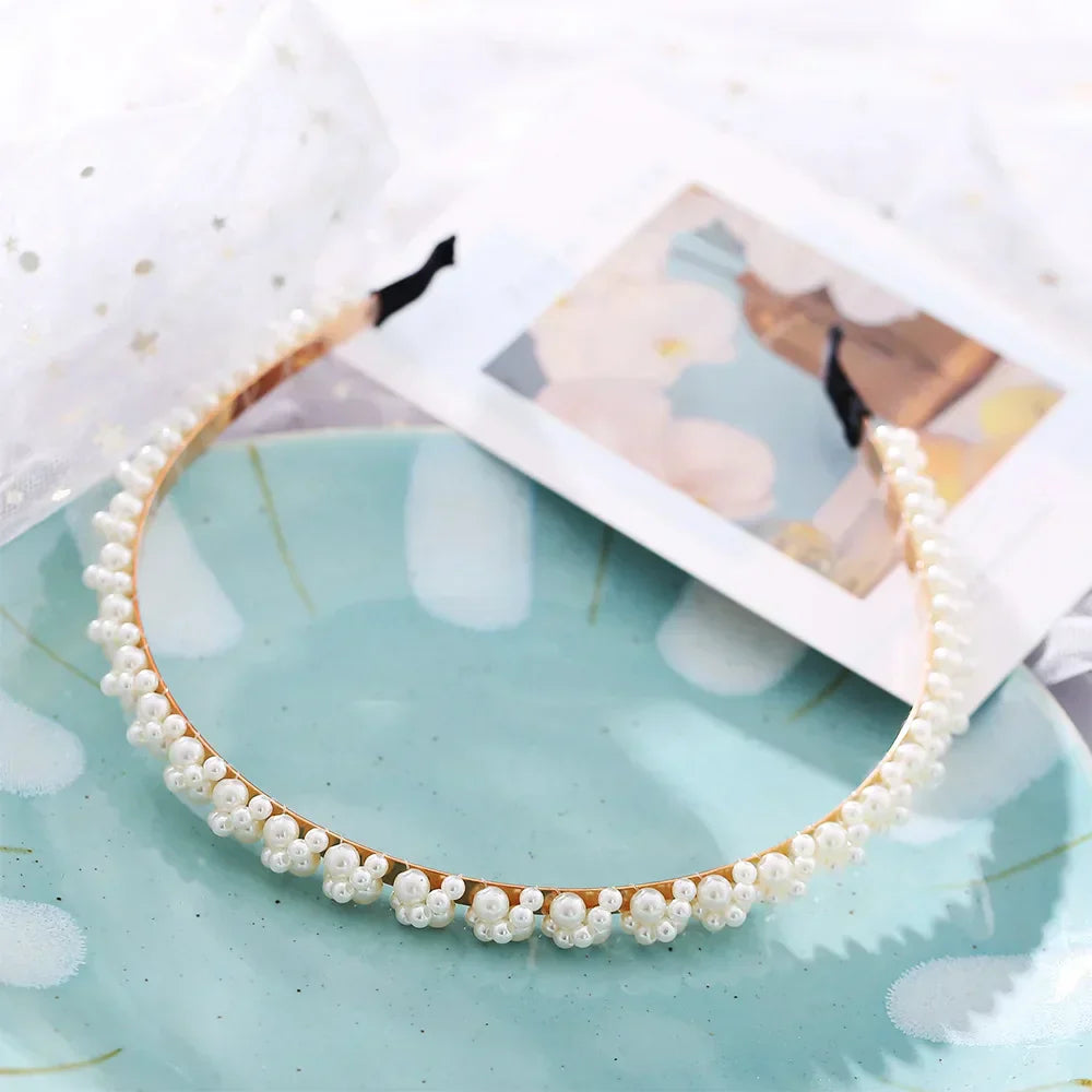 Modyle Full Pearl Hairband with floral pearls and elastic fit on blue plate